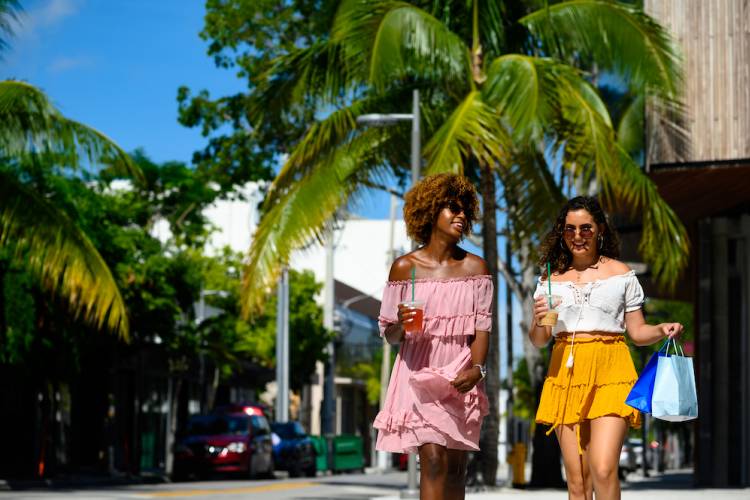 two women shopping in tropical outdoor setting